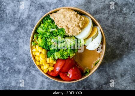 Healthy Organic Athlete Protein Food Bowl with Broccoli, Tricolor Quinoa, Peanut Butter Soy Sauce, Brown Rice, Egg and Hummus for Fitness Sport. Ready Stock Photo