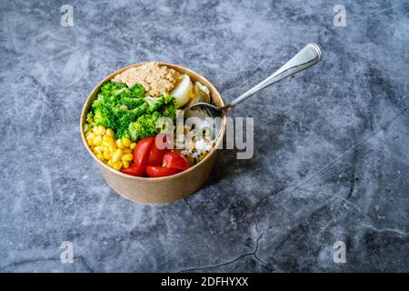 Healthy Organic Athlete Protein Food Bowl with Broccoli, Tricolor Quinoa, Peanut Butter Soy Sauce, Brown Rice, Egg and Hummus for Fitness Sport. Ready Stock Photo