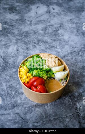 Healthy Organic Athlete Protein Food Bowl with Broccoli, Tricolor Quinoa, Peanut Butter Soy Sauce, Brown Rice, Egg and Hummus for Fitness Sport. Ready Stock Photo