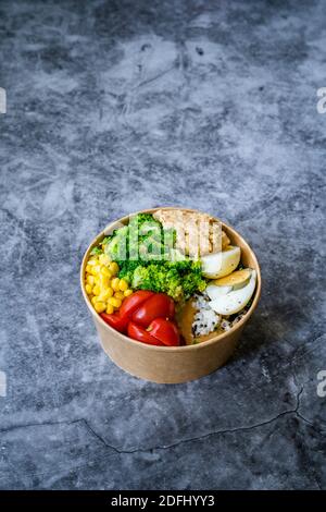 Healthy Organic Athlete Protein Food Bowl with Broccoli, Tricolor Quinoa, Peanut Butter Soy Sauce, Brown Rice, Egg and Hummus for Fitness Sport. Ready Stock Photo