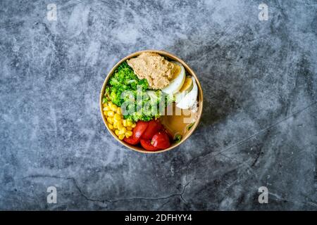 Healthy Organic Athlete Protein Food Bowl with Broccoli, Tricolor Quinoa, Peanut Butter Soy Sauce, Brown Rice, Egg and Hummus for Fitness Sport. Ready Stock Photo