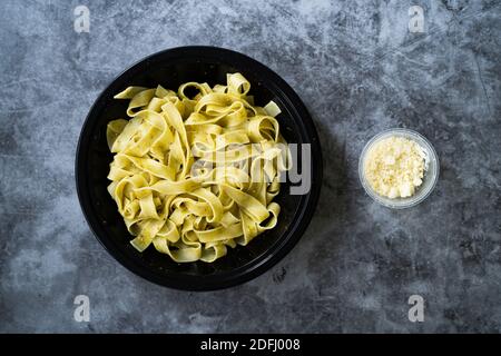 Grated cheddar cheese in plastic container Stock Photo - Alamy