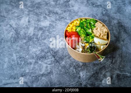 Healthy Organic Athlete Protein Food Bowl with Broccoli, Tricolor Quinoa, Peanut Butter Soy Sauce, Brown Rice, Egg and Hummus for Fitness Sport. Ready Stock Photo