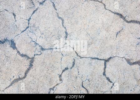 concrete slab with random cracks, gray beige stone texture background Stock Photo