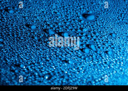 Colourful abstract background with water drops illuminated with blue LED light. Stock Photo