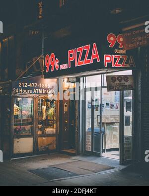 99 cent pizza shop at night, in the East Village, Manhattan, New York City Stock Photo