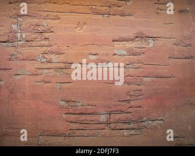 Partially visible reinforcement iron in a concrete wall painted red Stock Photo