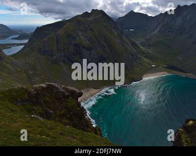 Stunning aerial view of popular sand beach Kvalvika with turquoise colored water surrounded by steep mountains and rocks on Moskenesøya, Lofoten. Stock Photo