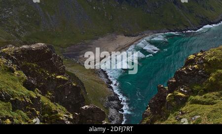 Beautiful aerial panoramic view of popular Kvalvika Beach with turquoise colored water and wild surge located on the northern coast of Norway. Stock Photo