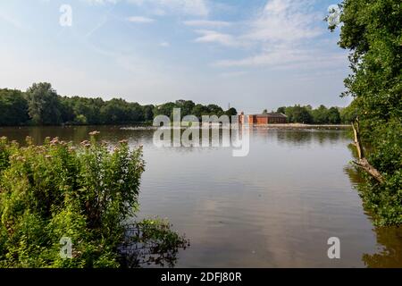 View across Rufford Lake towards Rufford mill in the grounds of Rufford Abbey Country Park, Nottinghamshire, UK. Stock Photo