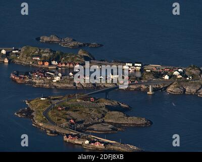 Stunning aerial view of small fishing village Hamnøy located on islands on coast of Moskenesøya island, Lofoten, Norway with bridge and houses. Stock Photo