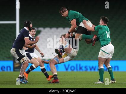 Ireland's CJ Stander (centre right) gathers possession from Scotland's Jonny Gray (centre left) during the Autumn Nations Cup match at the Aviva Stadium, Dublin. Stock Photo