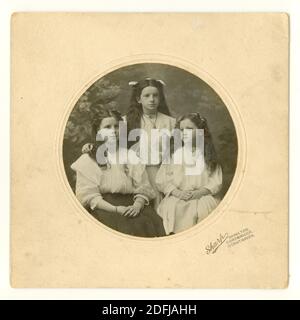 Original Edwardian mounted photograph of 2 sisters and a cousin, of teenage age, Ruby, Peggy and Dora, circa 1905, Hamilton near Glasgow, South Lanarkshire, Scotland, U.K. Stock Photo