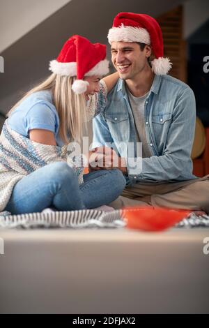 Young spouses having a good time in a holiday atmosphere at New Year celebration at home. New Year, family concept, together, love Stock Photo