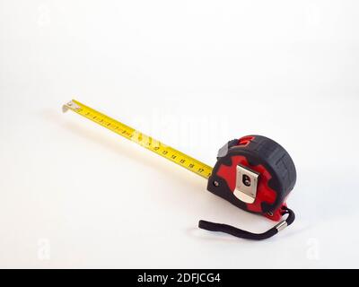 A double decimeter which is blocked on 20 centimeters, and a green ruler. Concept around works and measures. Stock Photo