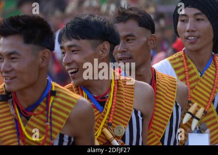 Young Naga tribesmen wearing traditional attire at central arena of Kisama Village in Nagaland India on 2 December 2016 Stock Photo