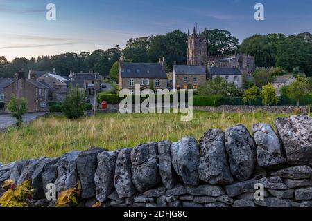 View of dry stone walls and St. Giles' Church at dusk, Hartington, Peak District National Park, Derbyshire, England, United Kingdom, Europe Stock Photo