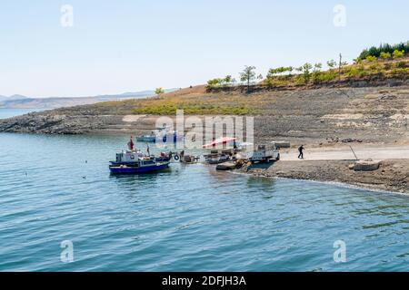 Pertek, Tunceli, Turkey-September 18 2020: Small fishing boats in Keban dam, selective focus Stock Photo