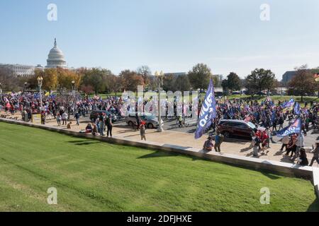 WASHINGTON, DC - NOV. 14, 2020: With US Capitol in the background, Trump supporters march to the Supreme Court in support of President Donald Trump, who refuses to concede the election. Event was organized by 'Women for America First,' 'Stop the Steal' and the 'Million MAGA March.' Stock Photo