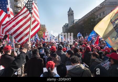 WASHINGTON, DC - NOV. 14, 2020: With Trump hotel in background, Trump supporters at Freedom Plaza rally in support of President Donald Trump, who refuses to concede the election. Event was organized by 'Women for America First,' 'Stop the Steal' and the 'Million MAGA March.'