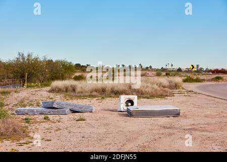 Mattresses and a washing machine illegally discarded in the desert near Tucson, Arizona Stock Photo