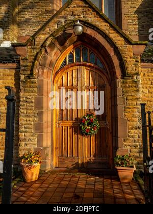 Front door to St John's United Reformed Church along Wilderspool Causeway in Warrington at Christmas Stock Photo