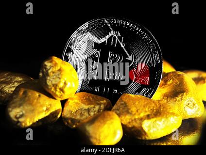 Bitcoin is marked with the flag of Blackbeard Pirate, against the background of gold ore Stock Photo