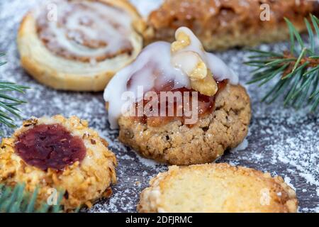 Close-up of various Christmas cookies surrounded with powdered sugar and fir branches Stock Photo