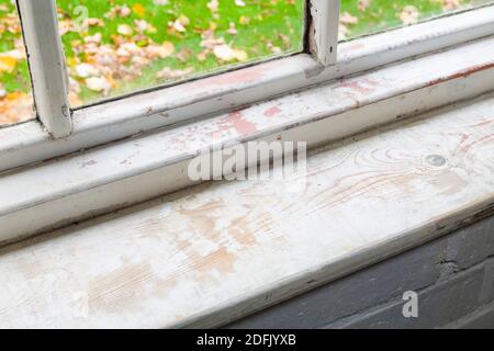 Window repair or restoration, sanding internal wood window in a home, UK Stock Photo