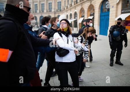 Counter protesters supporting the bioethics bill kicked out by security during a protest called by pro-life conservative activist group 'La Manif Pour Tous'against the bioethics bill on Medically Assisted Reproduction (PMA - Procreation Medicalement Assistee), in Paris, France, on October 10, 2020. Voted on August 1 in the second reading at the National Assembly, the bill, whose flagship measure is the opening of medically assisted procreation to all women, is due to be examined by the Senate on a date not yet set, towards the end of the year or early 2021. Photo by Raphael Lafargue/ABACAPRESS Stock Photo