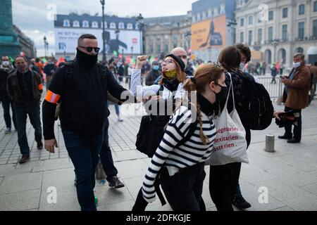 Counter protesters supporting the bioethics bill kicked out by security during a protest called by pro-life conservative activist group 'La Manif Pour Tous'against the bioethics bill on Medically Assisted Reproduction (PMA - Procreation Medicalement Assistee), in Paris, France, on October 10, 2020. Voted on August 1 in the second reading at the National Assembly, the bill, whose flagship measure is the opening of medically assisted procreation to all women, is due to be examined by the Senate on a date not yet set, towards the end of the year or early 2021. Photo by Raphael Lafargue/ABACAPRESS Stock Photo