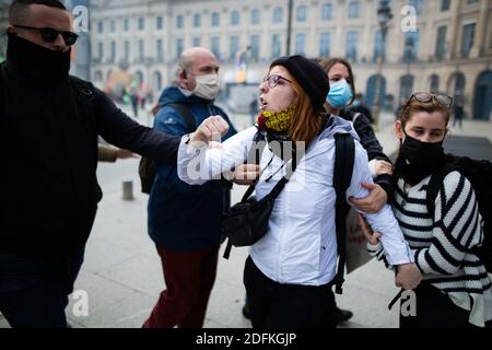 Counter protesters supporting the bioethics bill kicked out by security during a protest called by pro-life conservative activist group 'La Manif Pour Tous'against the bioethics bill on Medically Assisted Reproduction (PMA - Procreation Medicalement Assistee), in Paris, France, on October 10, 2020. Voted on August 1 in the second reading at the National Assembly, the bill, whose flagship measure is the opening of medically assisted procreation to all women, is due to be examined by the Senate on a date not yet set, towards the end of the year or early 2021. Photo by Raphael Lafargue/ABACAPRESS Stock Photo