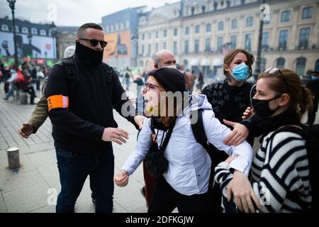 Counter protesters supporting the bioethics bill kicked out by security during a protest called by pro-life conservative activist group 'La Manif Pour Tous'against the bioethics bill on Medically Assisted Reproduction (PMA - Procreation Medicalement Assistee), in Paris, France, on October 10, 2020. Voted on August 1 in the second reading at the National Assembly, the bill, whose flagship measure is the opening of medically assisted procreation to all women, is due to be examined by the Senate on a date not yet set, towards the end of the year or early 2021. Photo by Raphael Lafargue/ABACAPRESS Stock Photo