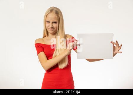 Teenage girl with blond hair in red dress holds paper. high quality Stock Photo