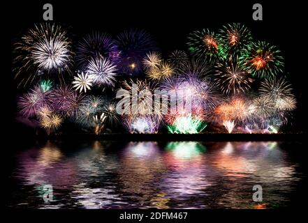 Colorful fireworks of various colors over night sky, fireworks on the beach Stock Photo