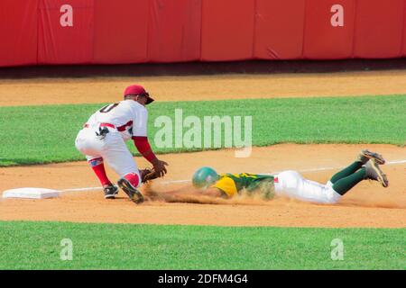 Mayabeque, Cuba, 3th Dec, 2020. Reinaldo Lazaga (slide) and Lázaro Martínez (fielder): match Pinar del Río-Mayabeque at Nelson Fernández Stadium. Stock Photo