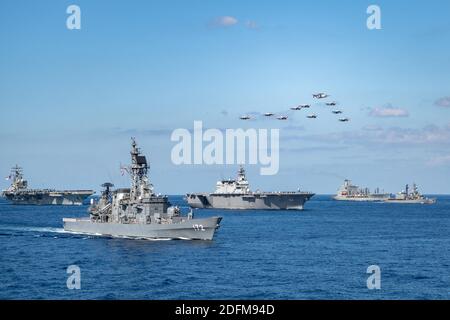 Handout photo dated October 26, 2020 of U.S. Navy ships assigned to the Ronald Reagan Carrier Strike Group joined ships of the Japan Maritime Self-Defense Force (JMSDF) Escort Flotilla 1, Escort Flotilla 4, and the Royal Canadian Navy in formation while aircraft from the U.S. Navy, U.S. Marine Corps, U.S. Air Force, JMSDF and Japan Air Self-Defense Force fly in formation during Keen Sword 21. U.S. Indo-Pacific Command forces and Japan Self-Defense Force units on Monday began the exercise Keen Sword 21 on military installations in mainland Japan. The joint biennial field training exercise for U Stock Photo