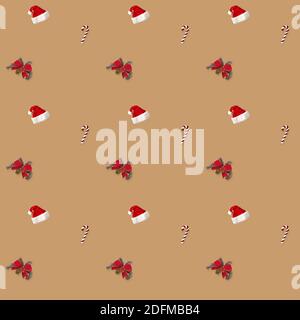 seamless pattern Santa hat, bow and candy cane candy cane on brown background Stock Photo