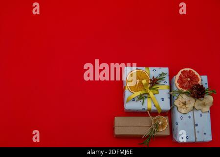 Christmas gifts in corner on red background. Flat lay Stock Photo