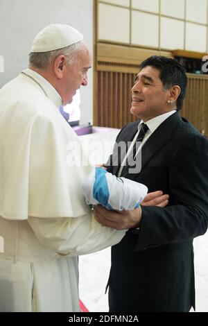File photo - Diego Maradona gives to Pope Francis a light blue-and-white jersey with his Argentine national team number 10 and the name Francisco on it at the Vatican on September 1, 2014. Pope Francis attends a special audience for players and organisers of a charity soccer match that was being played in Rome to promote peace and inter-religious cooperation. Pope Francis read an address to the participants in the Vatican's large audience hall and then each of them filed past the pontiff to greet and have their picture taken with him. Maradona chatted with his compatriot longer than most of th Stock Photo
