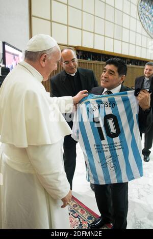 File photo - Diego Maradona gives to Pope Francis a light blue-and-white jersey with his Argentine national team number 10 and the name Francisco on it at the Vatican on September 1, 2014. Pope Francis attends a special audience for players and organisers of a charity soccer match that was being played in Rome to promote peace and inter-religious cooperation. Pope Francis read an address to the participants in the Vatican's large audience hall and then each of them filed past the pontiff to greet and have their picture taken with him. Maradona chatted with his compatriot longer than most of th Stock Photo