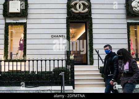 Pedestrians walk in front of a Chanel shop at Avenue Montaigne