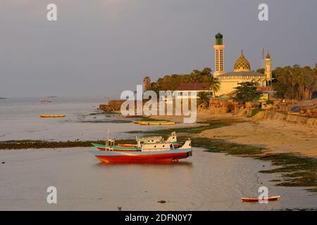 Indonesia Kupang - City Coastline with fishing boats and the Mosque Nurul Hidayah Stock Photo