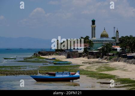 Indonesia Kupang - City Coastline with fishing boats and Mosque Nurul Hidayah Stock Photo