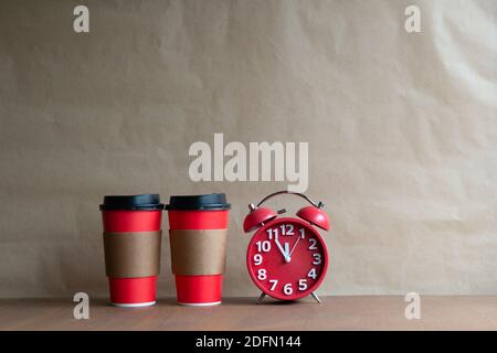 Coffee time concept - two disposable coffee cups and retro alarm clock on white background with copy space Stock Photo