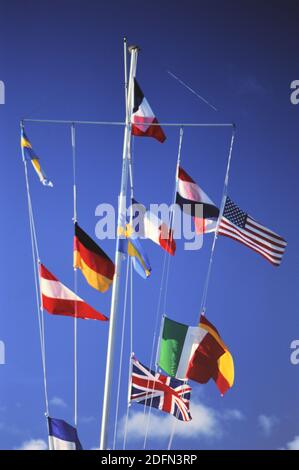 1990s St. Barts (Saint Barthélemy) – Flags of many nations fly over the marina at Gusavia's picturesque harbor ca. 1991 Stock Photo