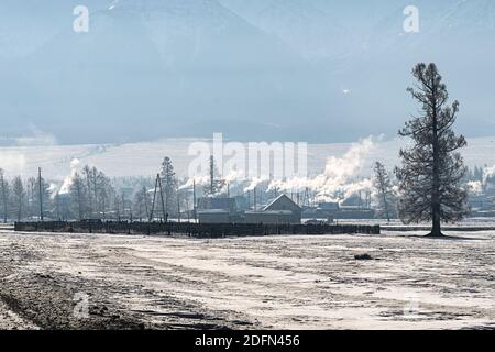 Early morning sunrise in steppes. Snow-covered pasture in the Altai Republic. The onset of winter, snow cover. Stock Photo