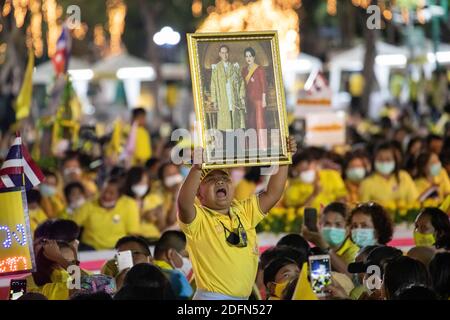 Bangkok, Thailand. 05th Dec, 2020. A young Thai royalist shout 'Long Live the King' while holding a portrait of late Thai King Bhumibol Adulyadej and Queen Sirikit in front of the Grand Palace at Sanam Luang during a ceremony to celebrate the birthday of late Thai King Bhumibol Adulyadej (Rama 9). Thai King Maha Vajiralongkorn (Rama 10), took part during the ceremony along with other members of the Royal Family. Credit: SOPA Images Limited/Alamy Live News Stock Photo