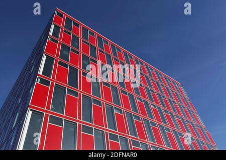 Capricorn office building, red facade, blue sky, Uniper headquarters, Media Harbour Duesseldorf, North Rhine-Westphalia, Germany Stock Photo