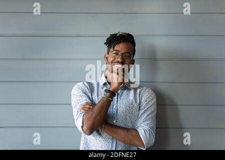 Happy young confident african american man on wall background. Stock Photo